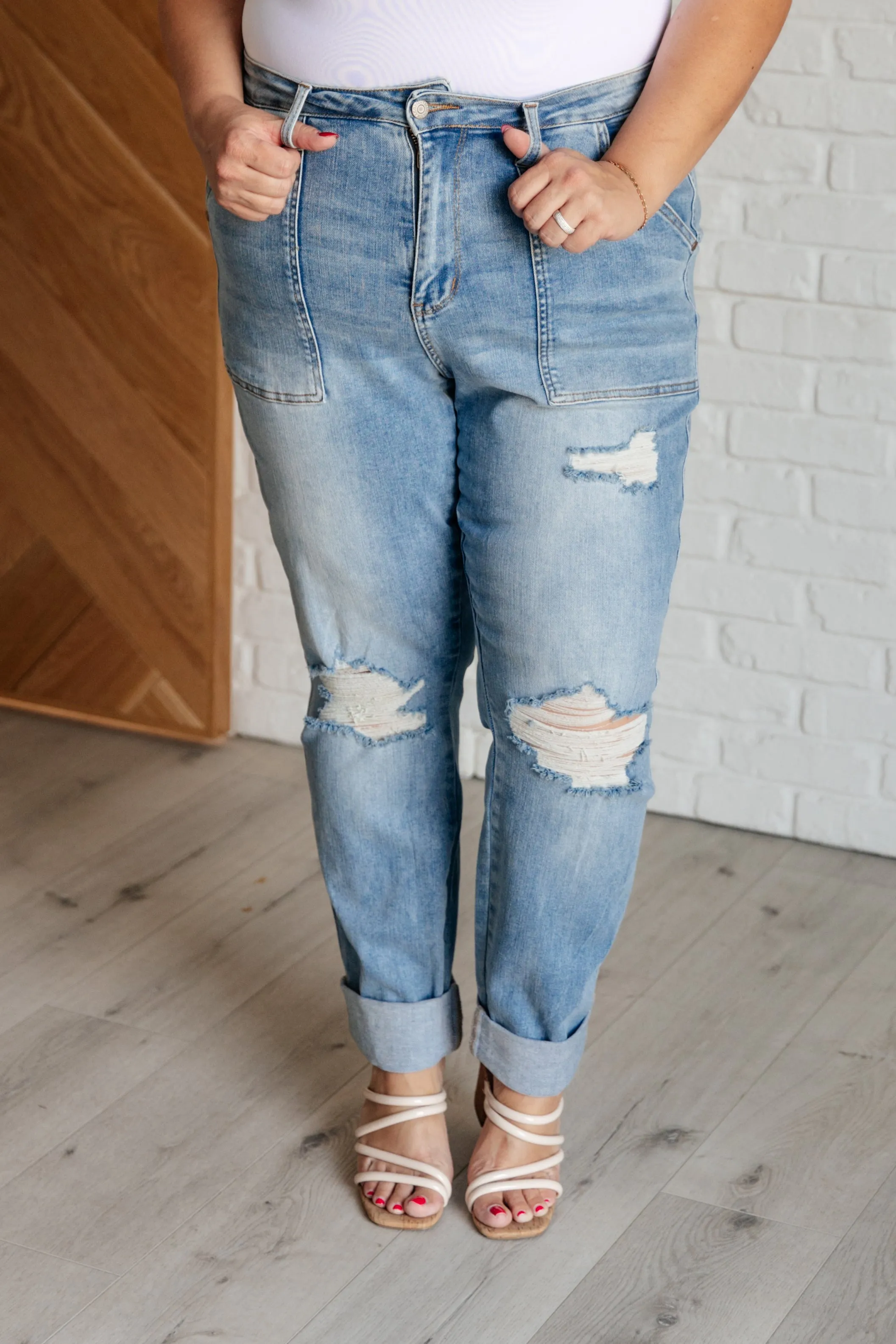 Aiden distressed boyfriend jeans with high rise and patch pockets.